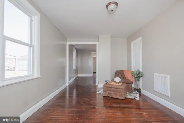 a view of hallway with wooden floor