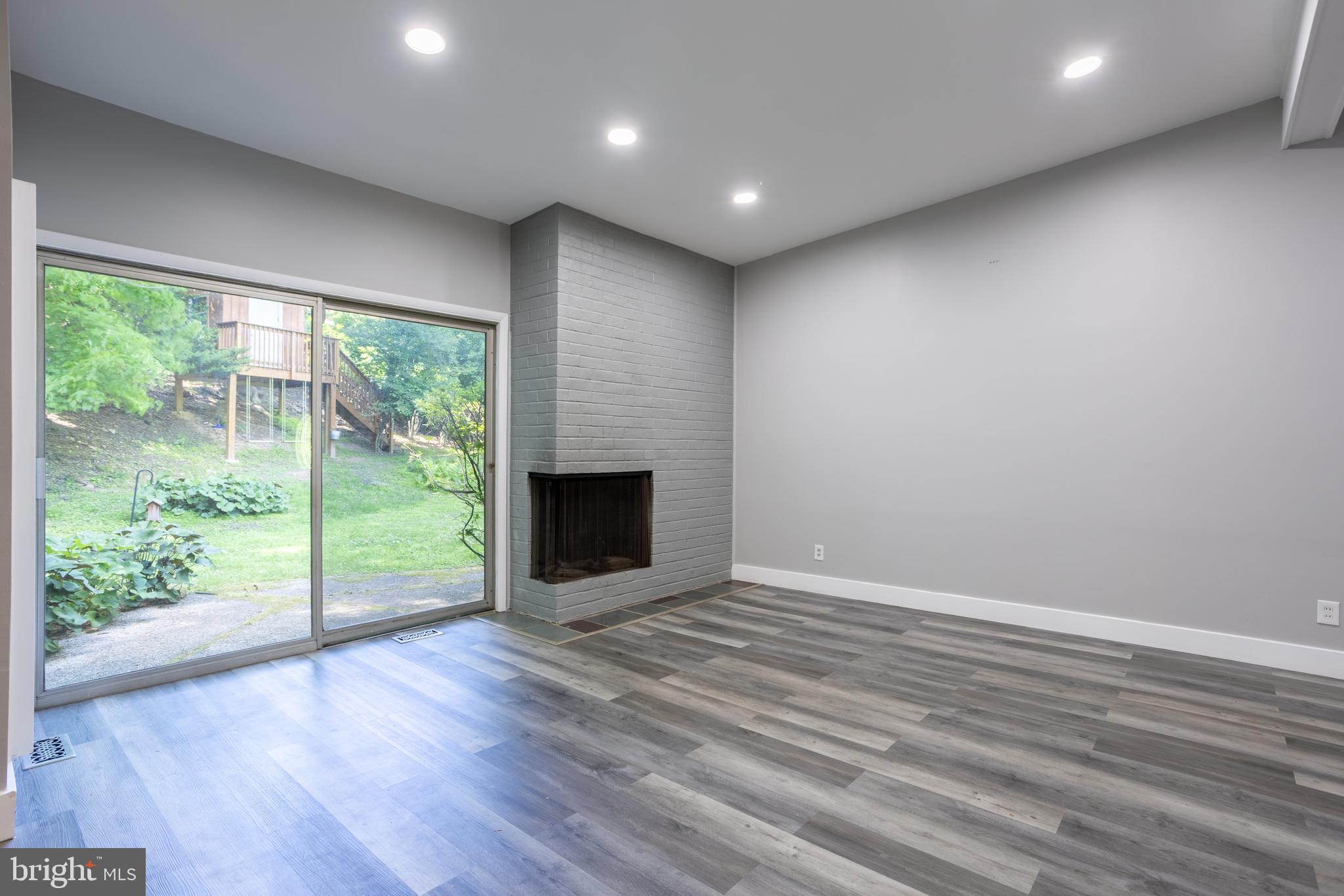 3207 Midfield Road Pikesville, MD 21208 - Photo 7 of 45 a view of empty room with wooden floor and fireplace