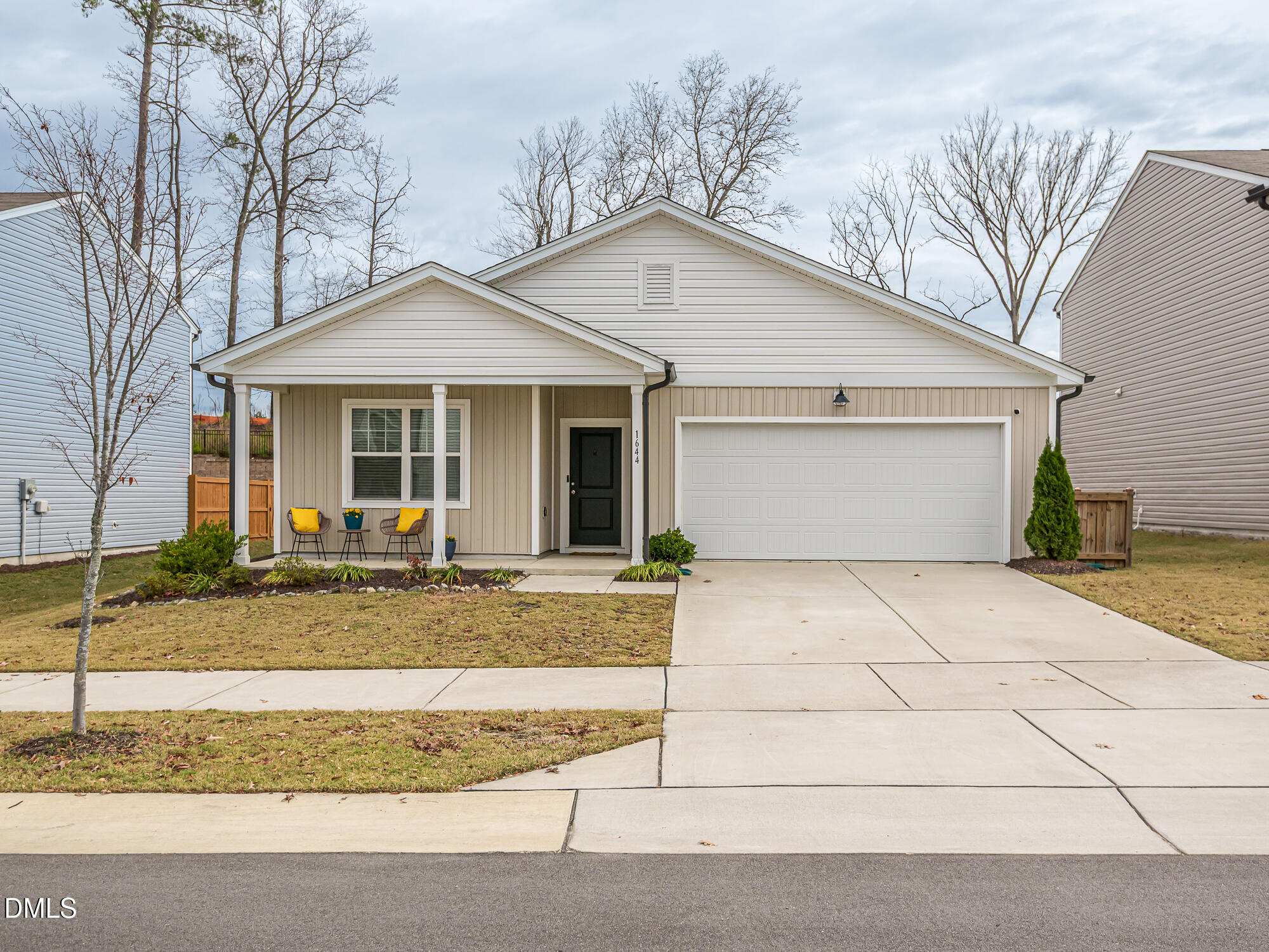 1644 Arapahoe Ridge Drive Raleigh, NC 27604 - Photo 1 of 41 a view of a white house with a small yard and large tree