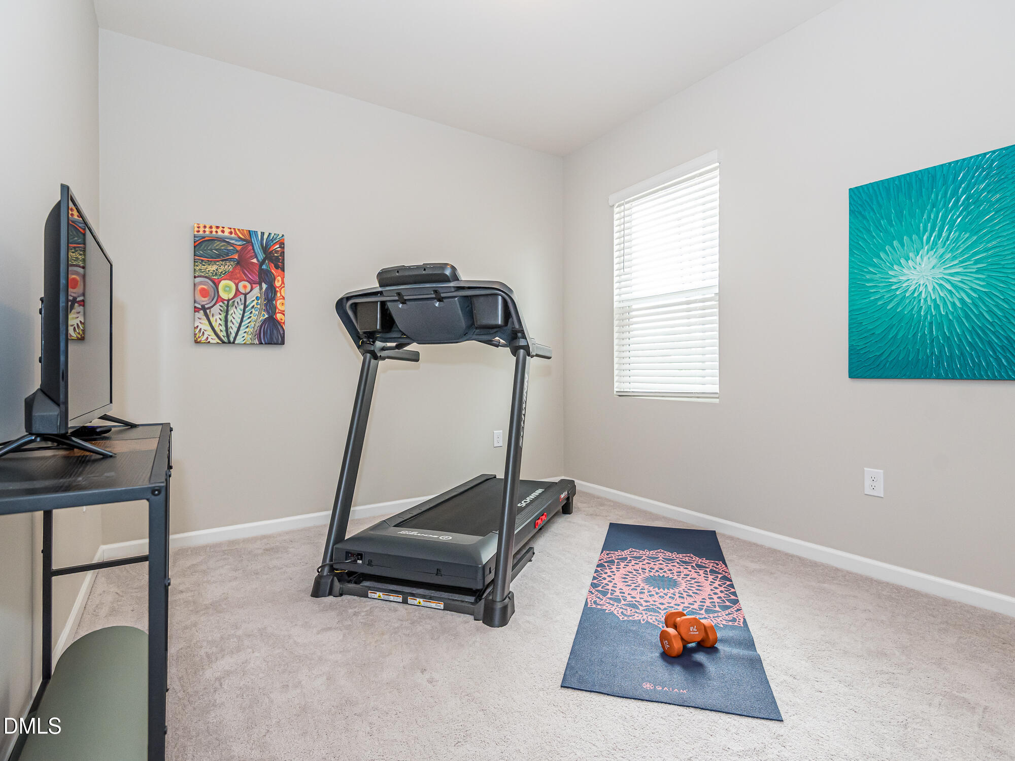 1644 Arapahoe Ridge Drive Raleigh, NC 27604 - Photo 14 of 41 a room with gym equipment and a flat screen tv