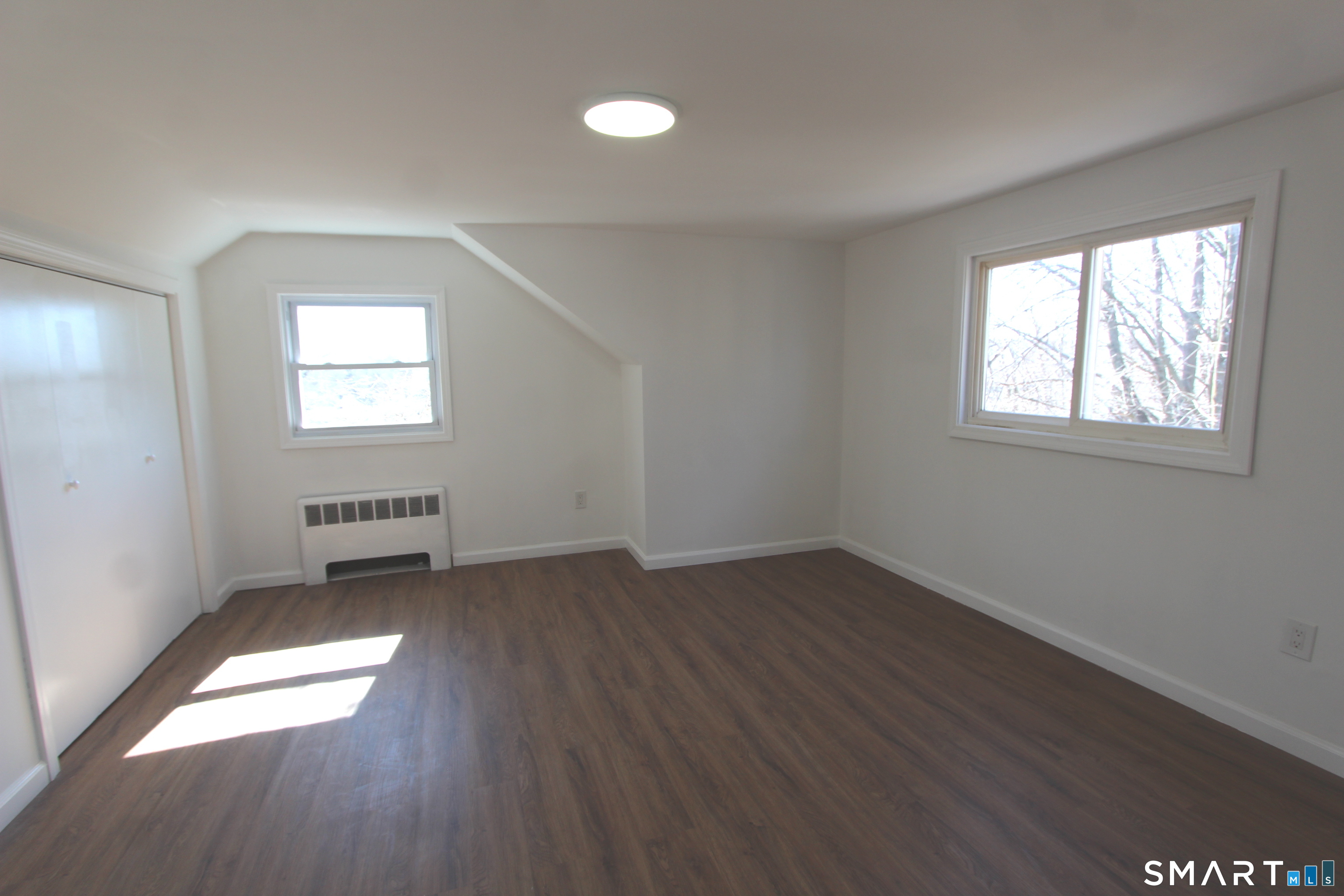 52 Glen Haven Road New Haven, CT 06513 - Photo 11 of 15 an empty room with wooden floor and windows