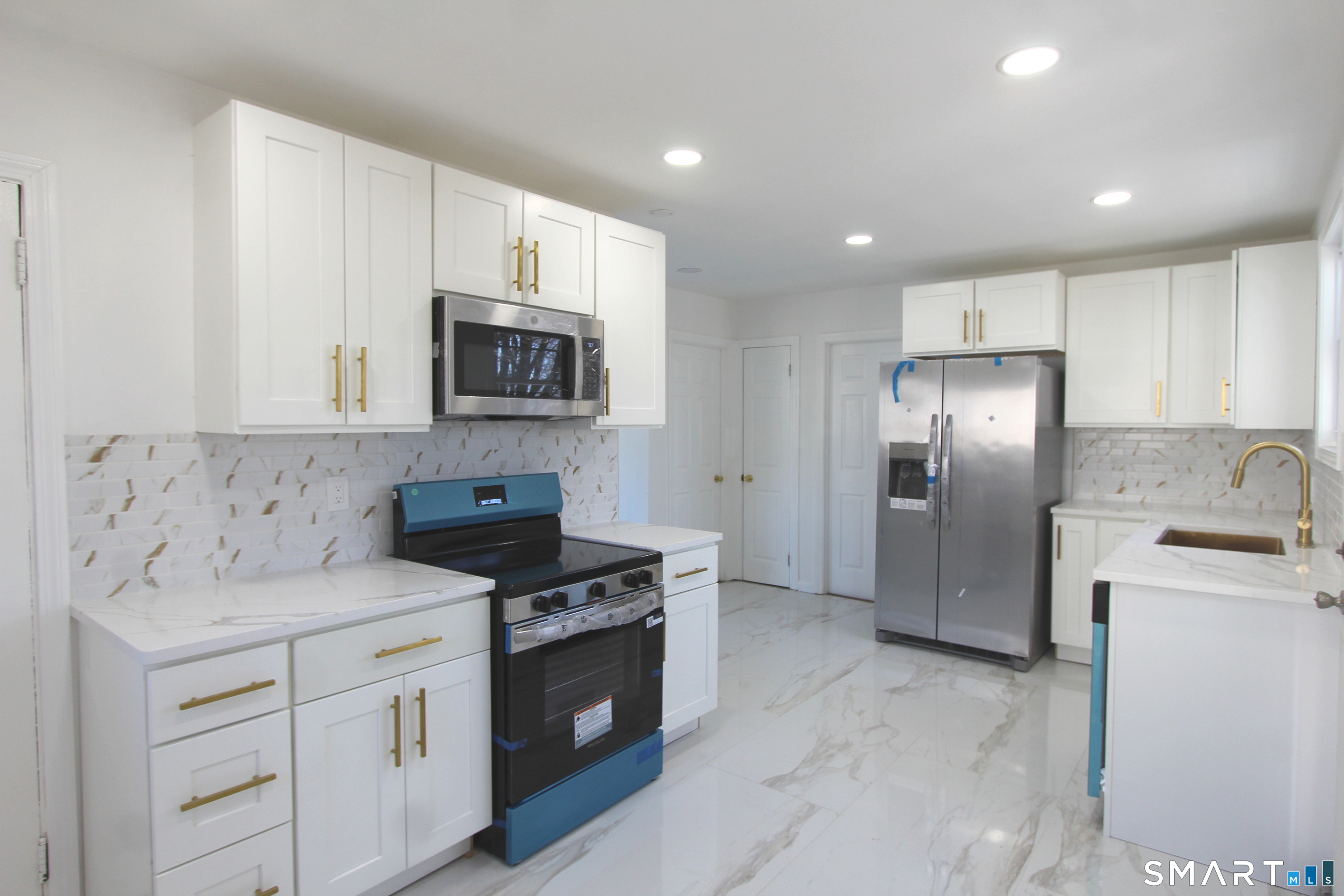 52 Glen Haven Road New Haven, CT 06513 - Photo 3 of 15 a kitchen with stainless steel appliances granite countertop a stove a refrigerator and a sink