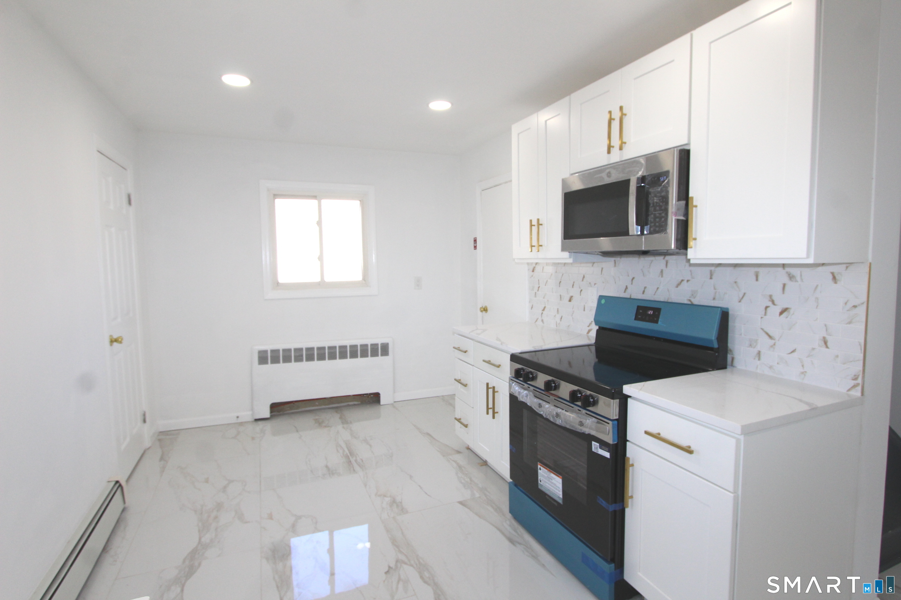 52 Glen Haven Road New Haven, CT 06513 - Photo 5 of 15 a kitchen with a stove and a microwave