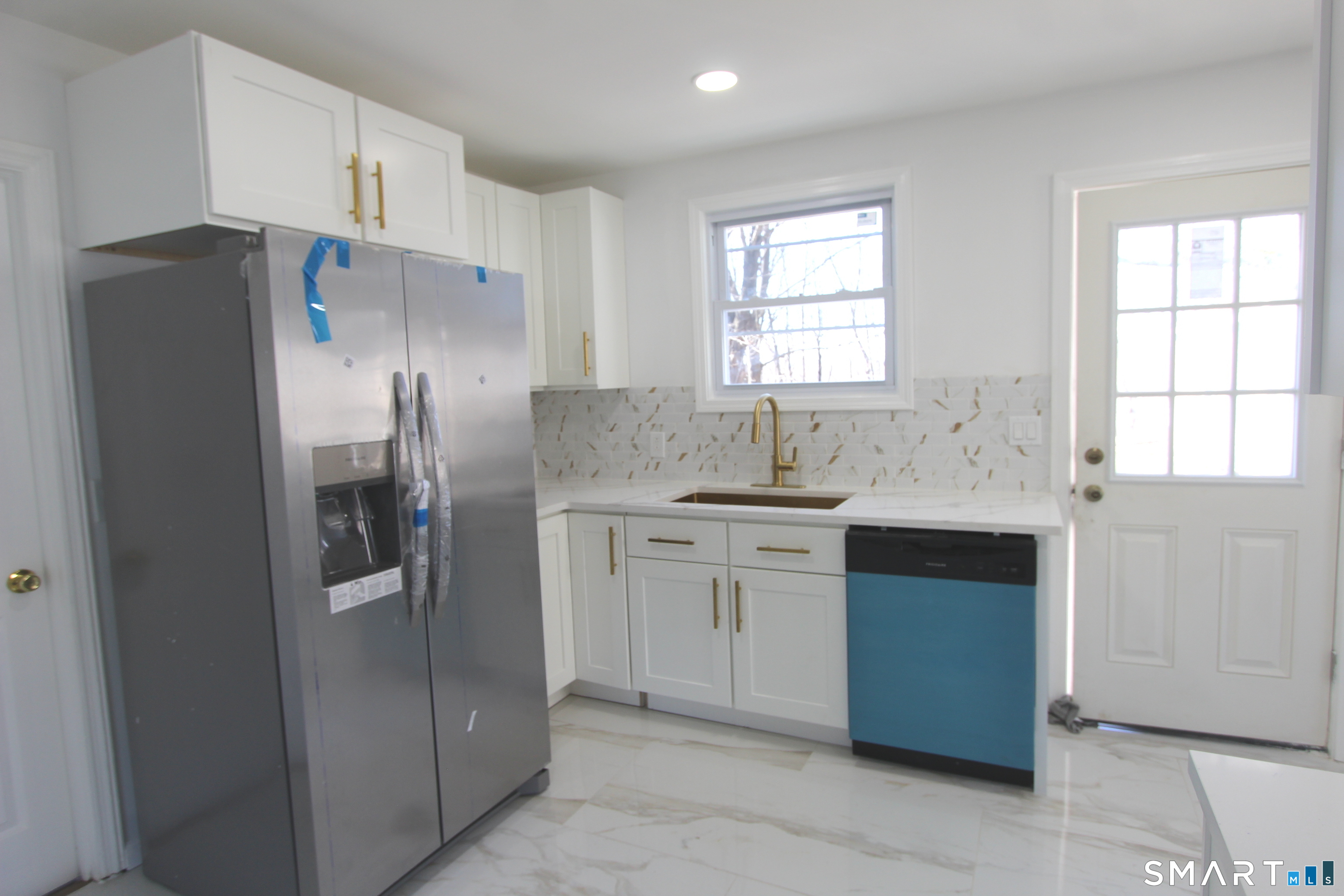 52 Glen Haven Road New Haven, CT 06513 - Photo 6 of 15 a kitchen with stainless steel appliances a refrigerator sink and microwave