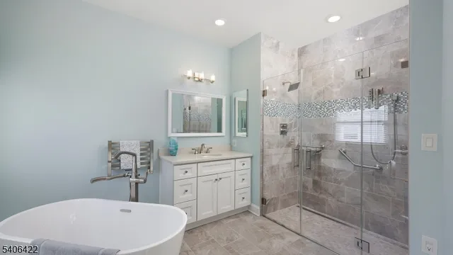 a bathroom with a bathtub shower sink mirror and toilet