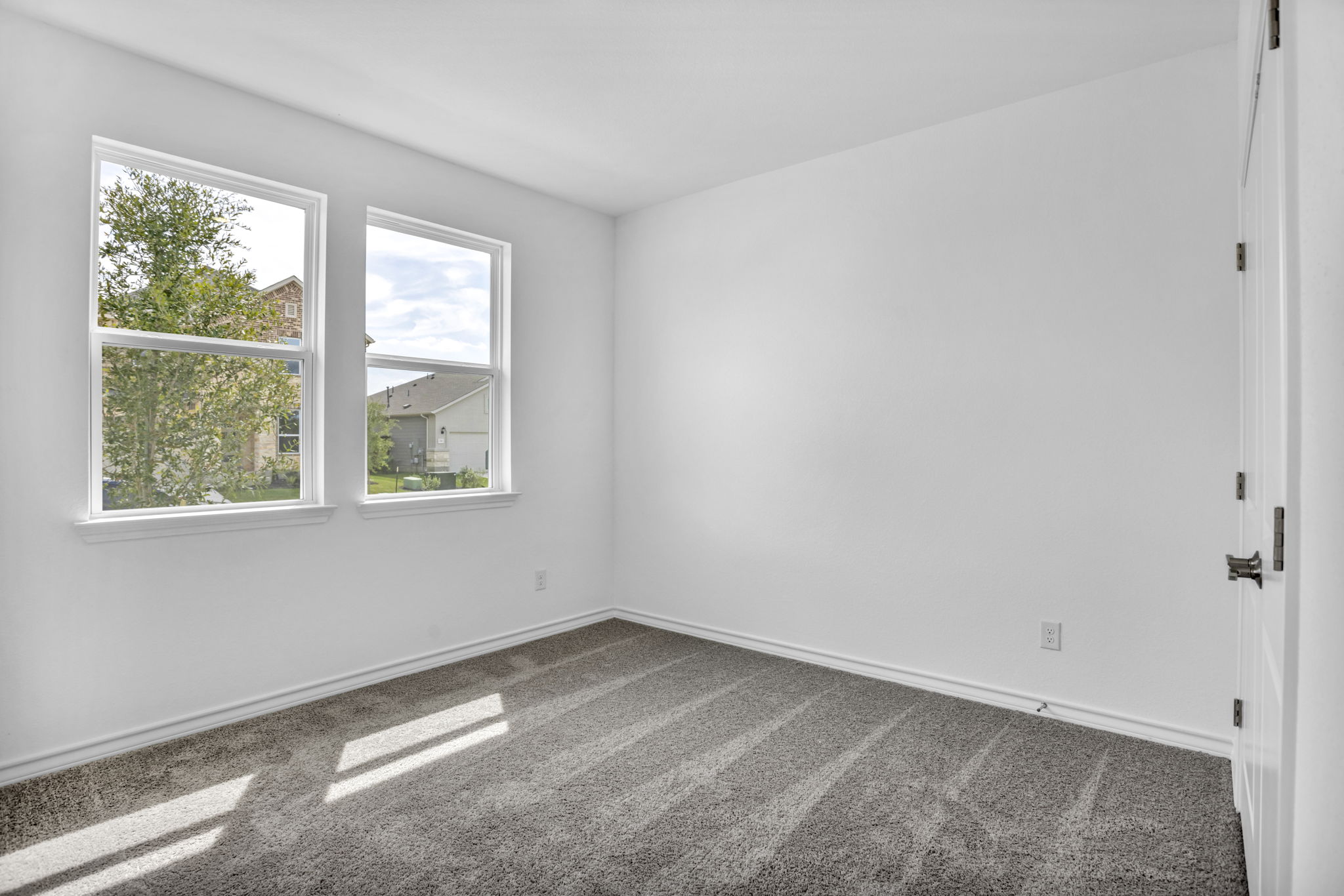131 Adeline Road Hutto, TX 78634 - Photo 7 of 30 Natural illumination fills this room, offering a neutral foundation for personalized decor.