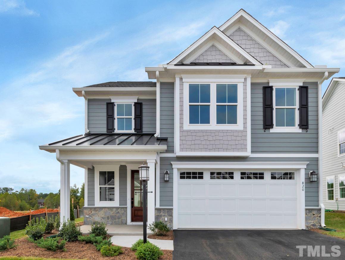 155 DUNLOE Loop Raleigh, NC 27603 - Photo 1 of 1 a view of a white house with large windows and a small yard