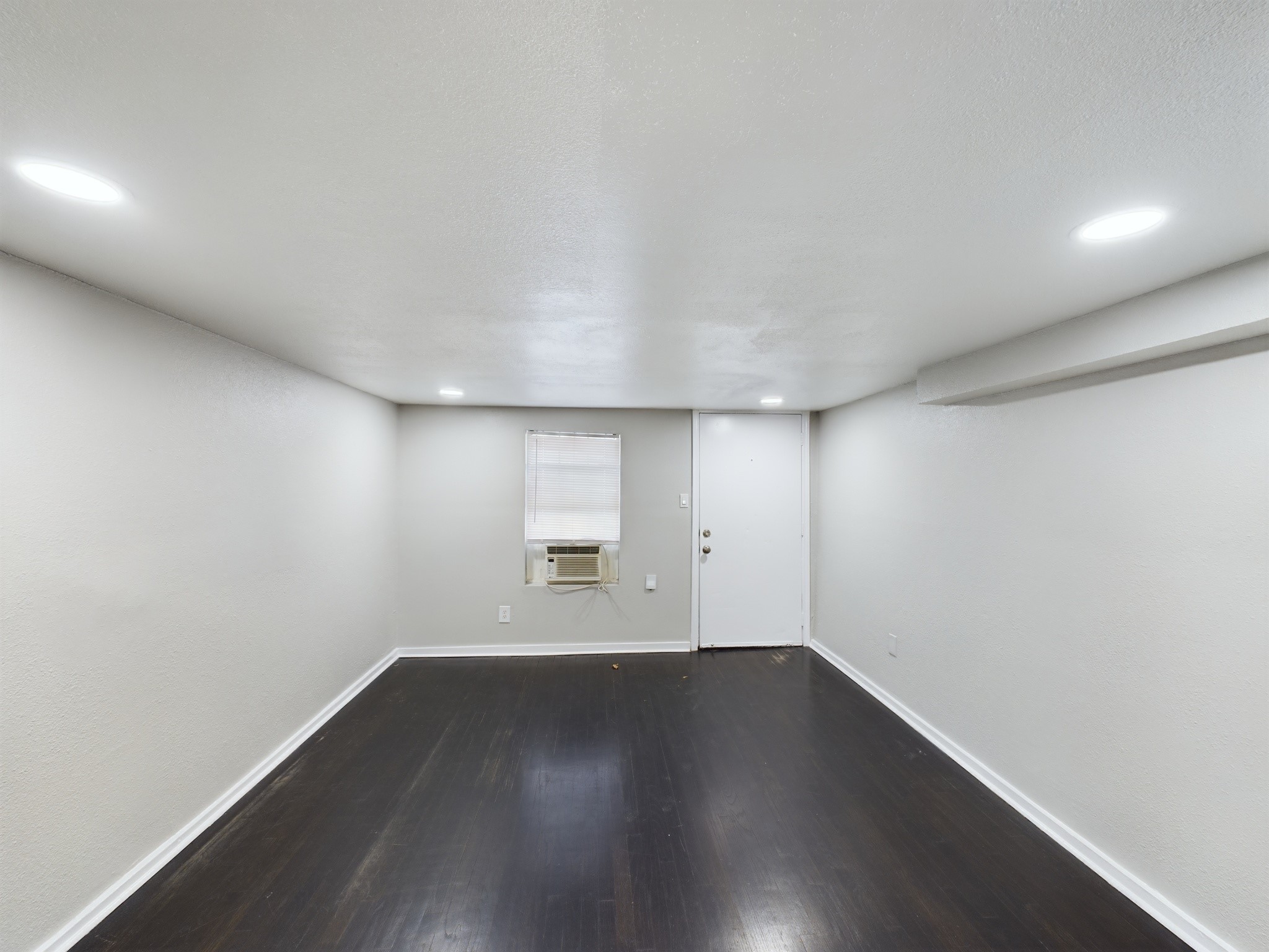 605 Enid 1/2 2 Street Houston, TX 77009 - Photo 4 of 7 an empty room with wooden floor and windows
