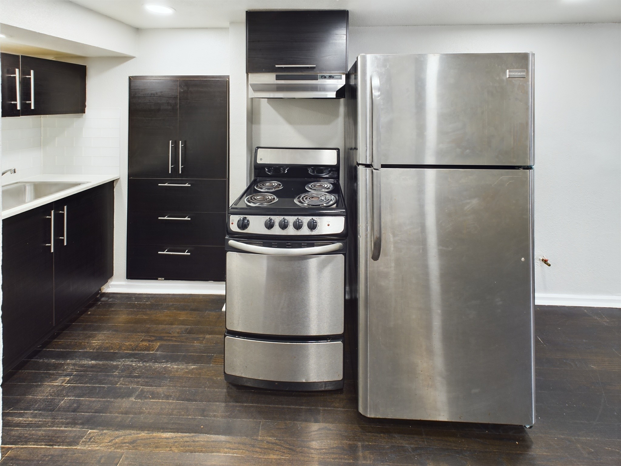 605 Enid 1/2 2 Street Houston, TX 77009 - Photo 6 of 7 a kitchen with stainless steel appliances granite countertop a refrigerator and a stove