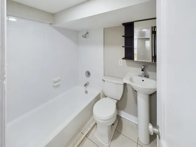a white toilet sitting next to a bathroom sink