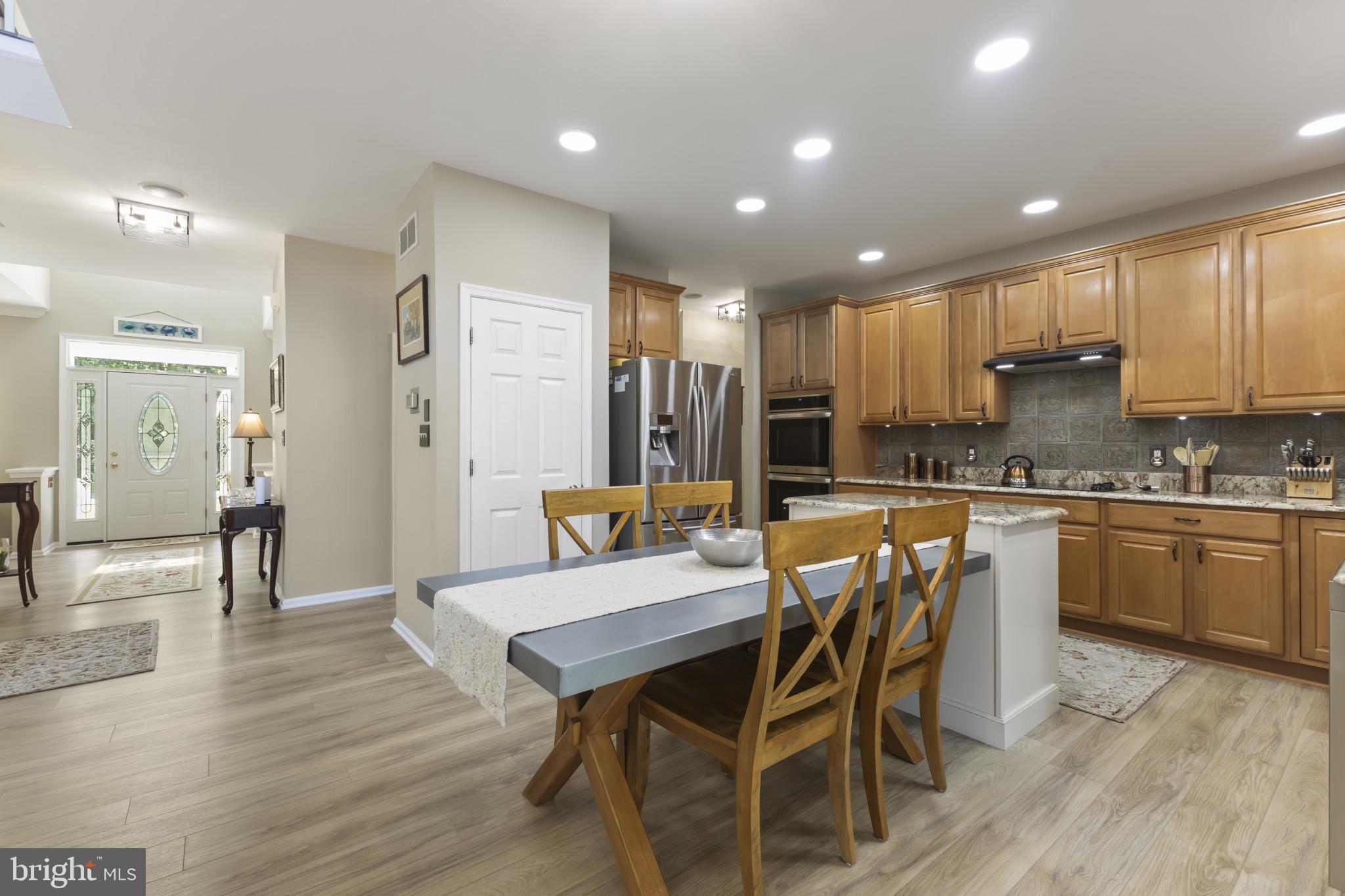 104 Woods Road Chester, MD 21619 - Photo 12 of 38 a large kitchen with a table and chairs in it
