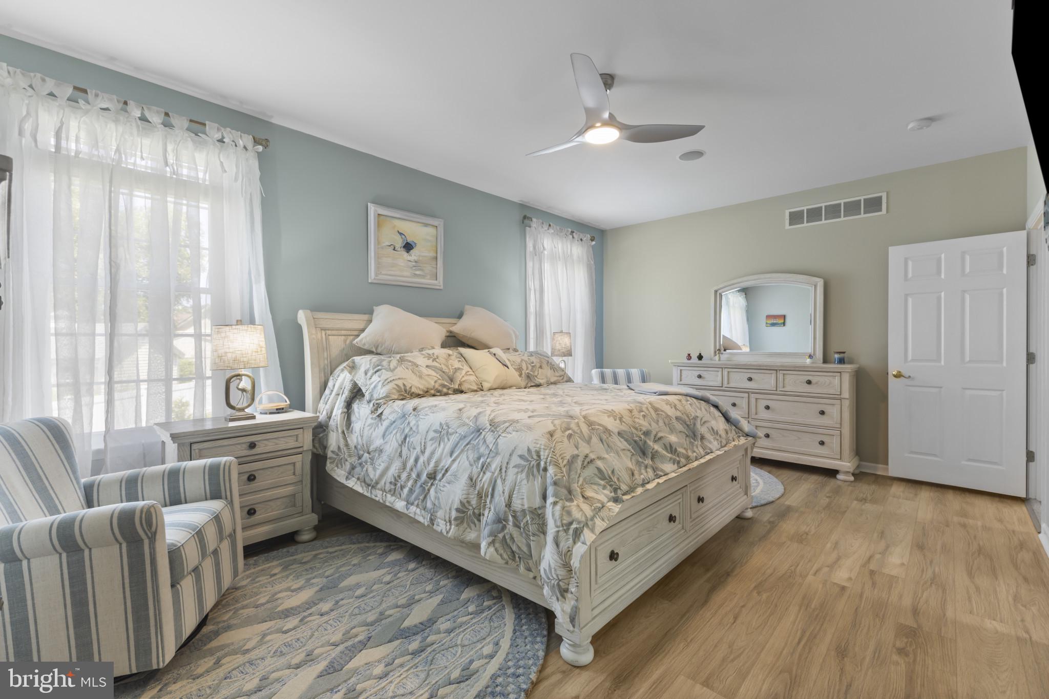 104 Woods Road Chester, MD 21619 - Photo 18 of 38 a spacious bedroom with a bed and a couch