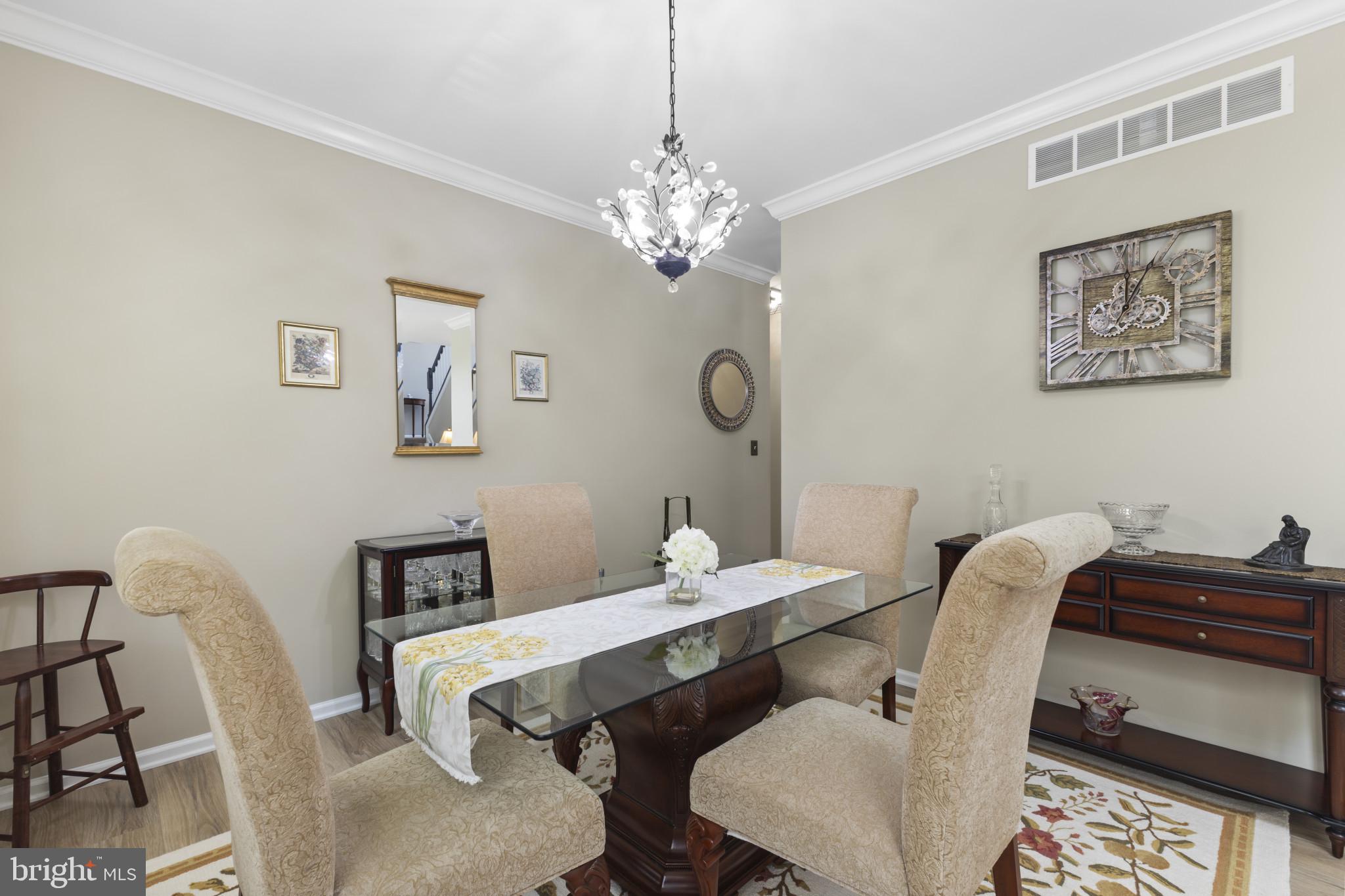 104 Woods Road Chester, MD 21619 - Photo 6 of 38 a view of a dining room with furniture and chandelier