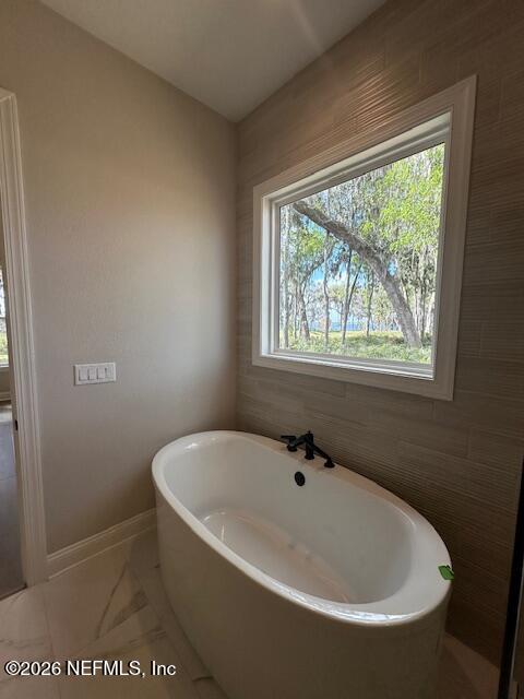 62 Slip Cove St. Johns, FL 32259 - Photo 44 of 54 a white bath tub sitting in a bathroom