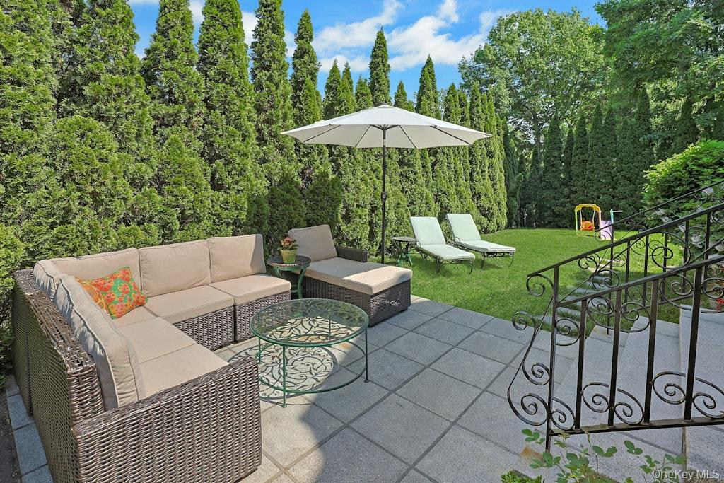 97 Underhill Road Scarsdale, NY 10583 - Photo 34 of 39 a view of a patio with furniture and a garden