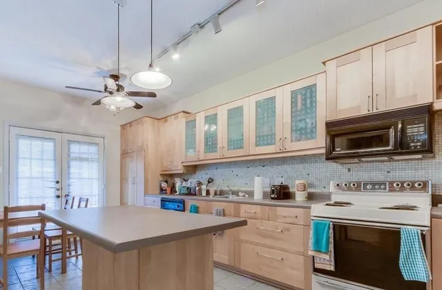 a kitchen with stainless steel appliances granite countertop a stove sink microwave and cabinets