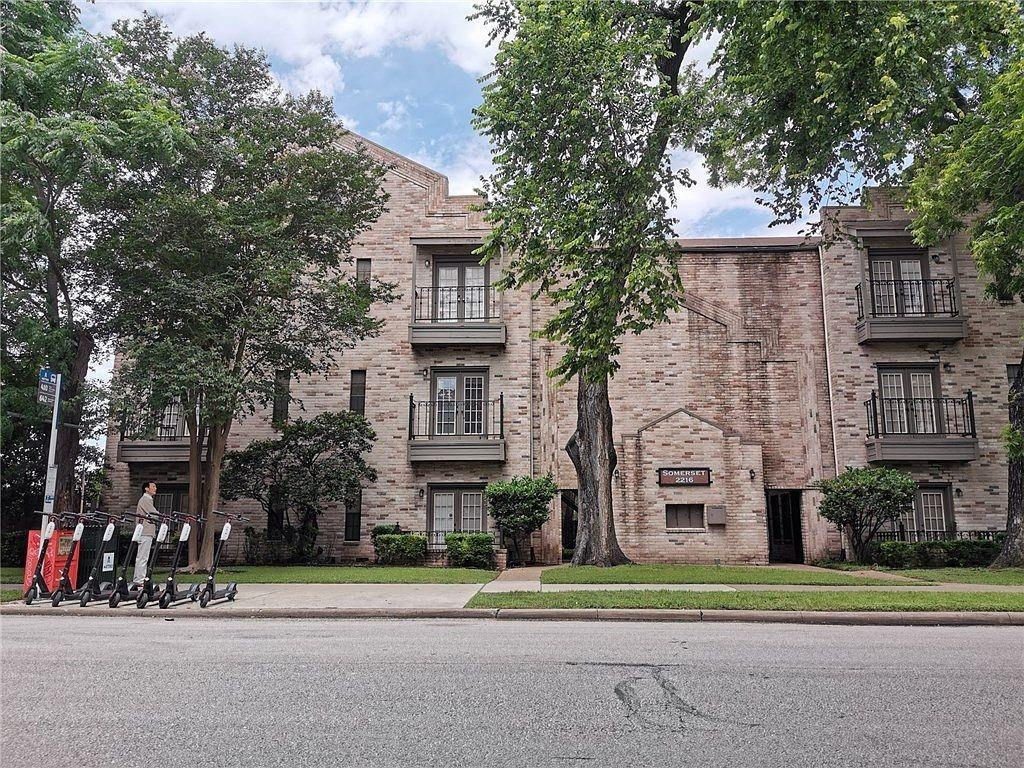 2216 San Gabriel Street, Unit 107 Austin, TX 78705 - Photo 3 of 7 a front view of a building with a garden and trees