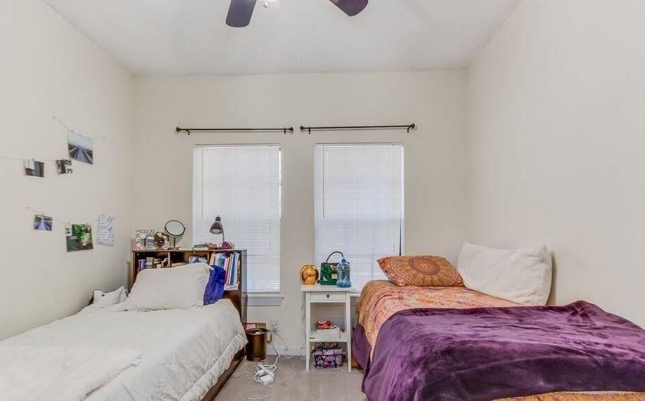 2216 San Gabriel Street, Unit 107 Austin, TX 78705 - Photo 4 of 7 a bedroom with a bed and a table