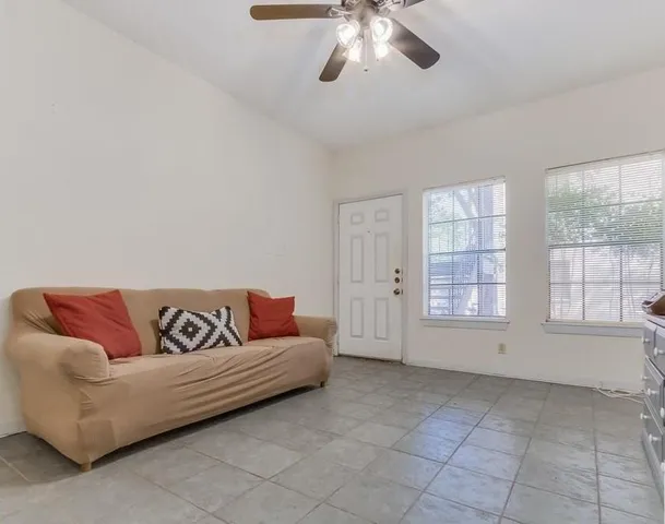 a living room with furniture and windows