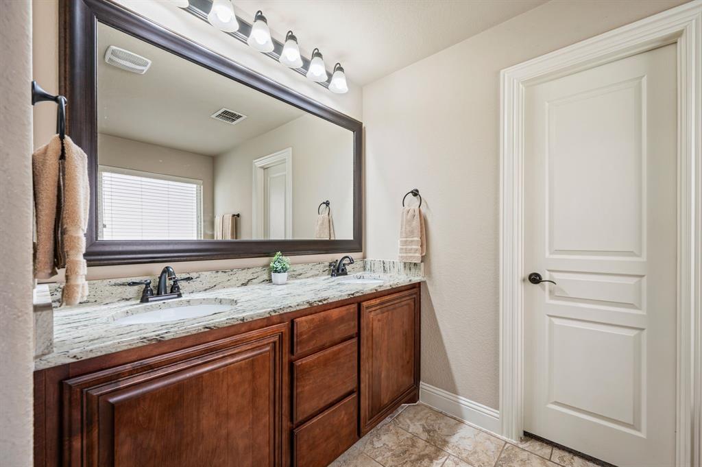 5209 Edgebrook Way Fort Worth, TX 76244 - Photo 17 of 33 a bathroom with a granite countertop sink and a mirror