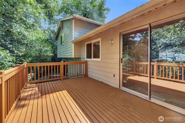 a view of a wooden deck with a yard