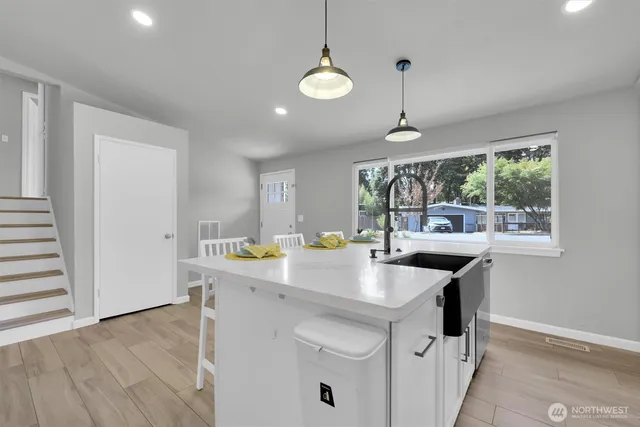 a kitchen that has a sink a stove and a window