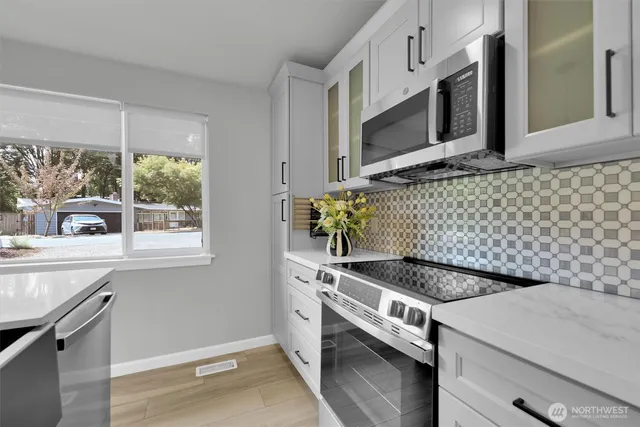 a kitchen with granite countertop cabinets and window