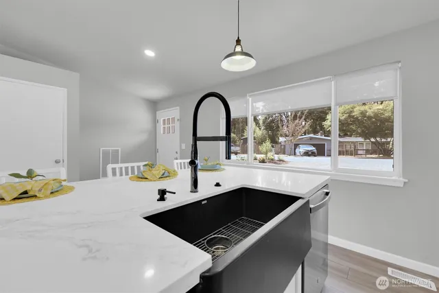 a kitchen with a sink appliances and a window