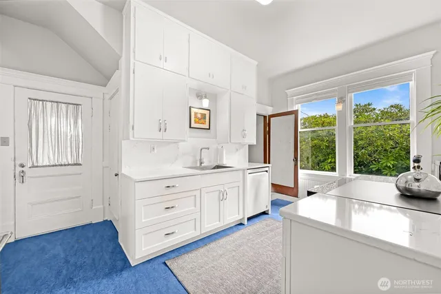 a kitchen with sink cabinets and wooden floor