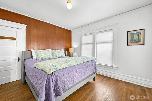 a bed sitting in a bedroom next to a window