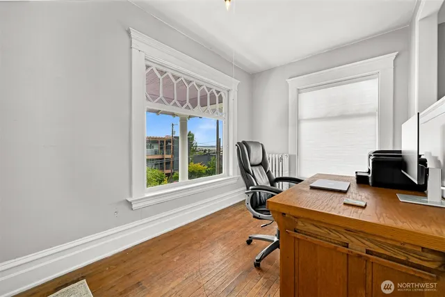 a view of a workspace with furniture and a window