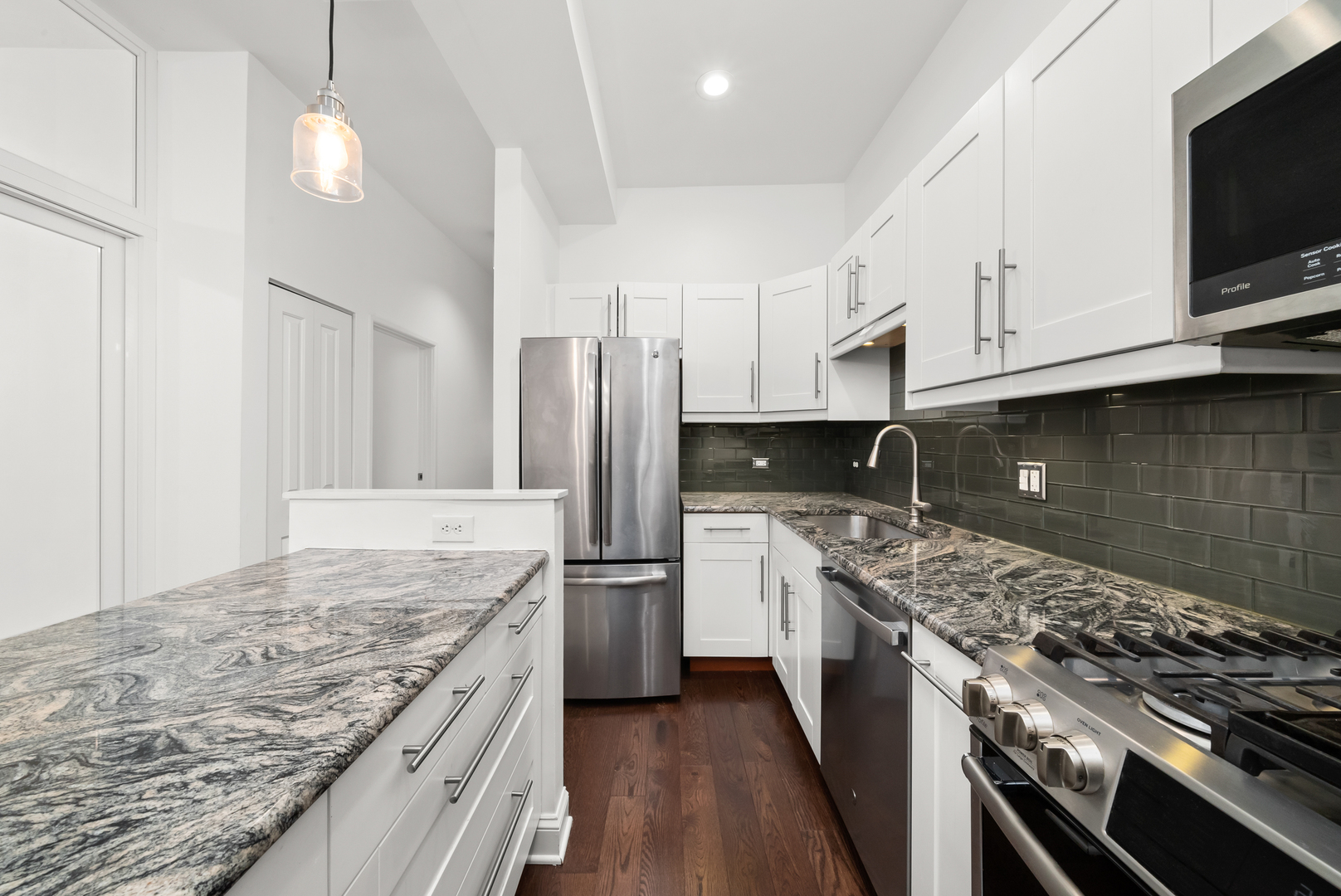 3055 North Seminary Avenue, Unit 3S Chicago, IL 60657 - Photo 7 of 23 a kitchen with stainless steel appliances granite countertop a stove a sink and a refrigerator