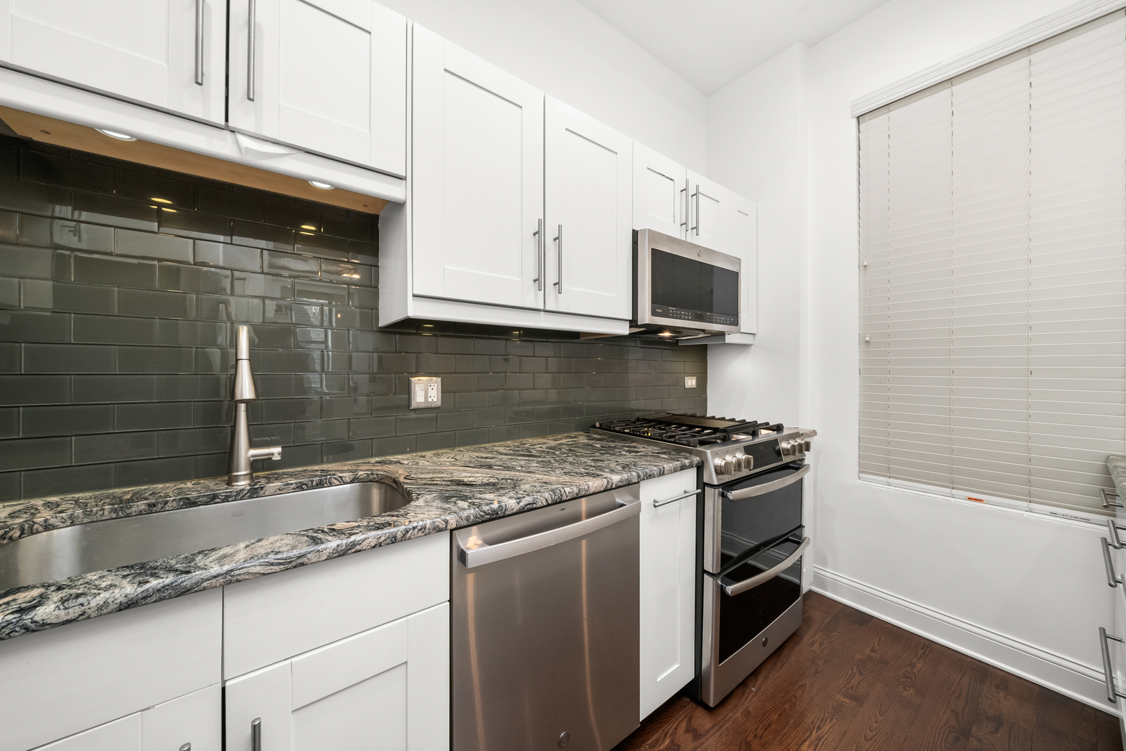 3055 North Seminary Avenue, Unit 3S Chicago, IL 60657 - Photo 8 of 23 a kitchen with granite countertop cabinets stainless steel appliances and a sink