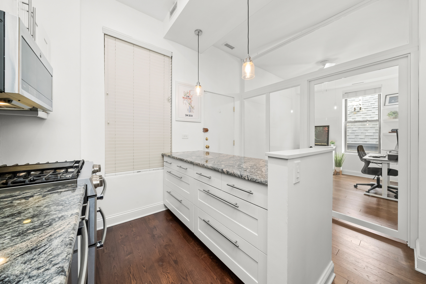 3055 North Seminary Avenue, Unit 3S Chicago, IL 60657 - Photo 9 of 23 a kitchen with granite countertop white cabinets and white appliances