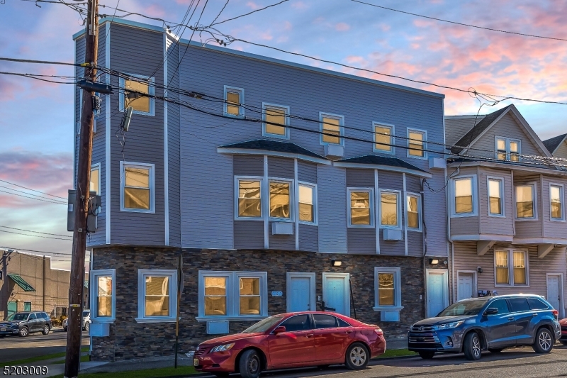 167 Smith Street, Unit 1L Elizabeth, NJ 07201 - Photo 1 of 8 a front view of residential houses with cars parked