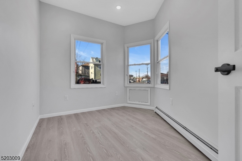 167 Smith Street, Unit 1L Elizabeth, NJ 07201 - Photo 8 of 8 wooden floor in an empty room with a window