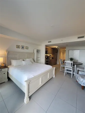 a bed room with a bed and a chair