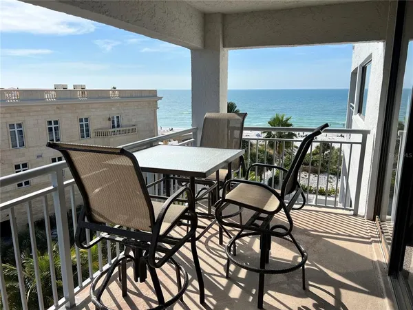a view of a chairs and table in the balcony