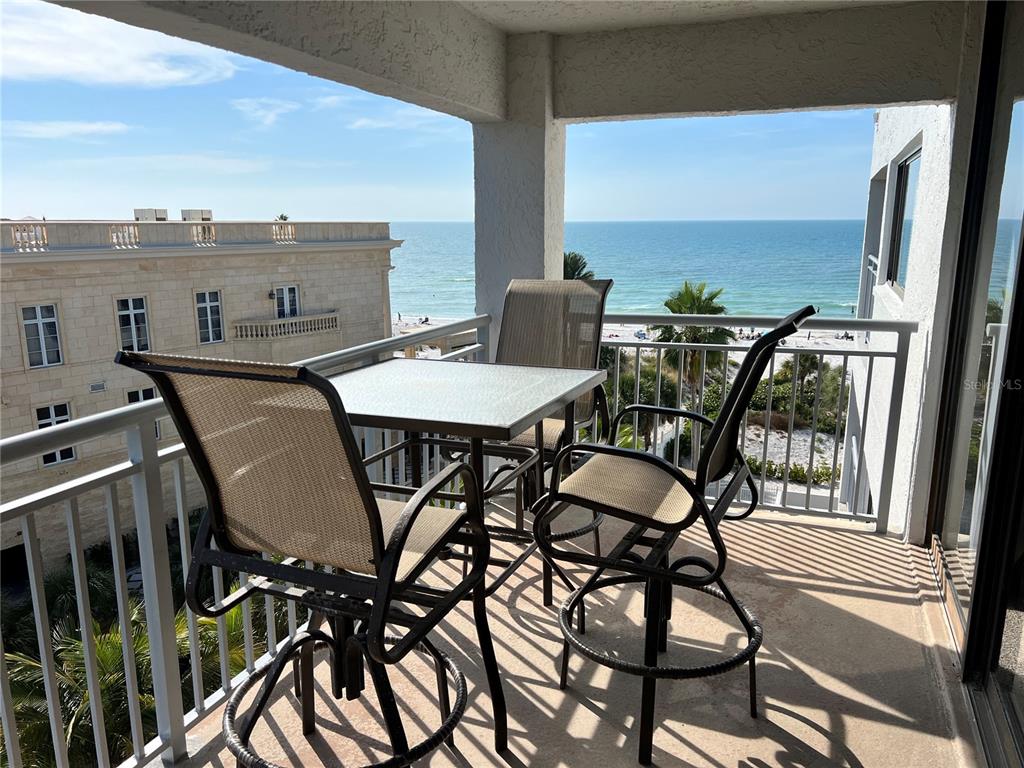 a view of a chairs and table in the balcony