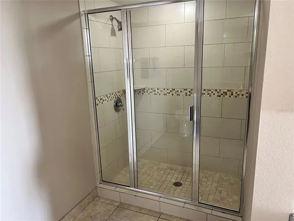 a bathroom with a glass shower door