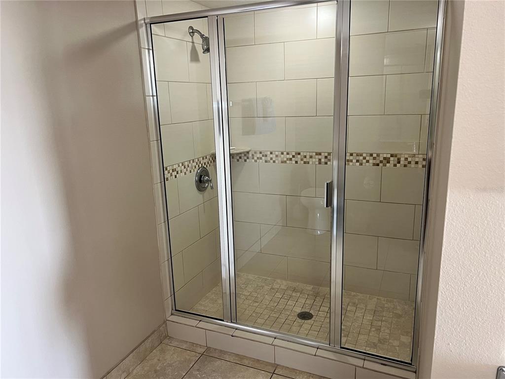 1001 Point Of Rocks Road, Unit 608 Sarasota, FL 34242 - Photo 11 of 33 a bathroom with a glass shower door