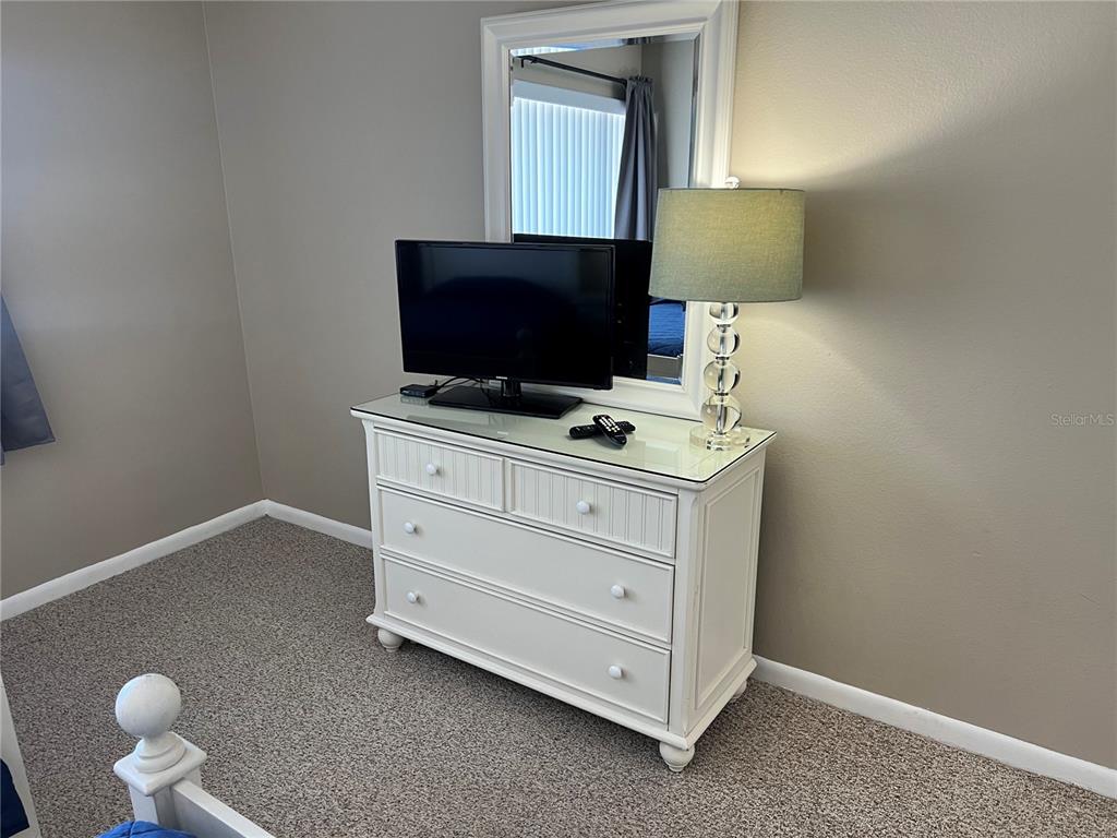 1001 Point Of Rocks Road, Unit 608 Sarasota, FL 34242 - Photo 13 of 33 a room with furniture and flat screen tv