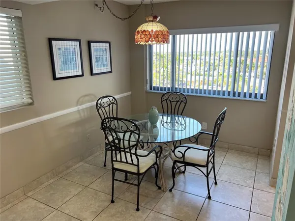 a view of a dining room with furniture and chandelier