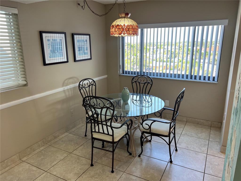 1001 Point Of Rocks Road, Unit 608 Sarasota, FL 34242 - Photo 4 of 33 a view of a dining room with furniture and chandelier