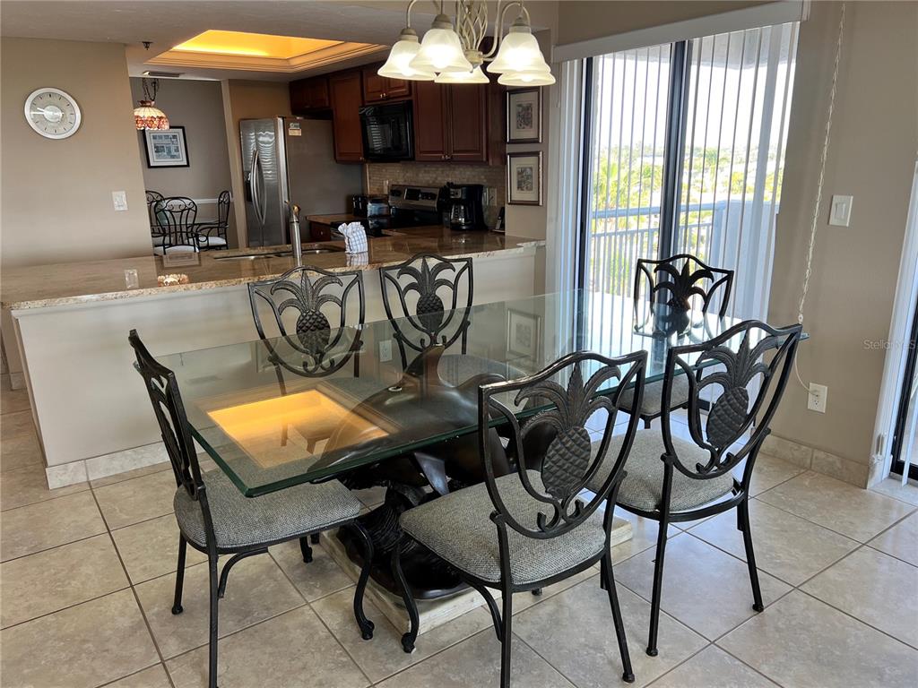 1001 Point Of Rocks Road, Unit 608 Sarasota, FL 34242 - Photo 6 of 33 a view of a dining room with furniture and a window