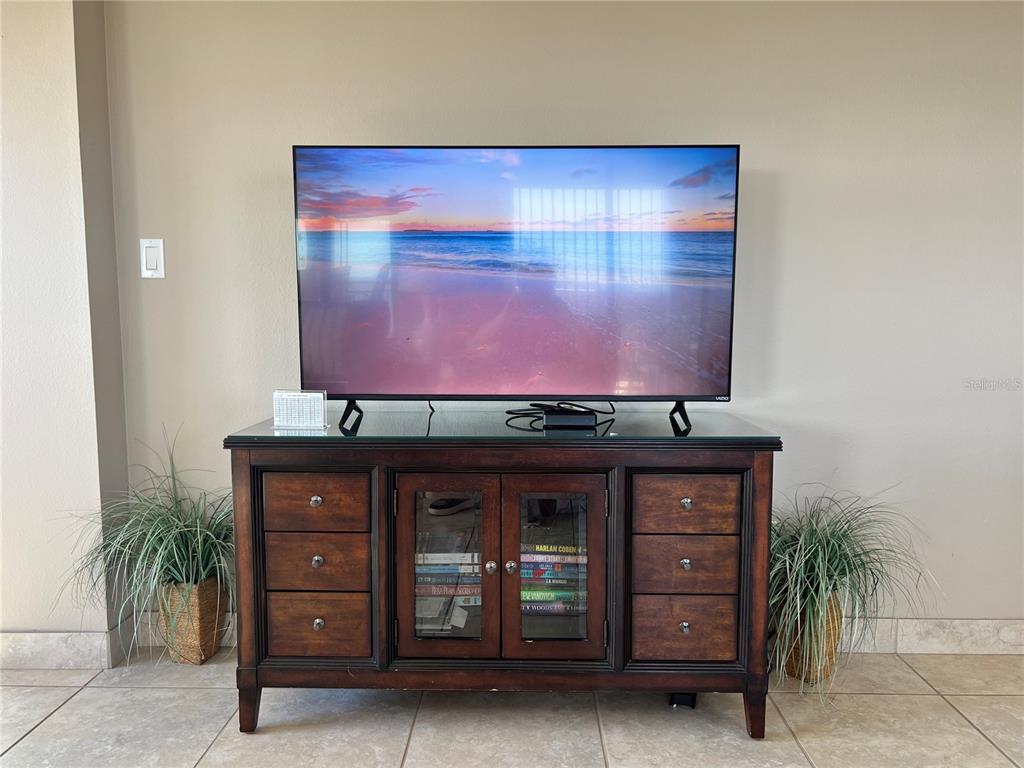 1001 Point Of Rocks Road, Unit 608 Sarasota, FL 34242 - Photo 7 of 33 a living room with furniture and a flat screen tv