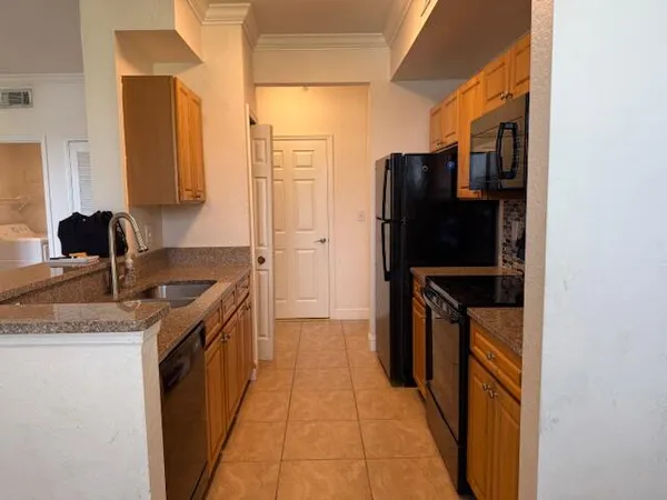 a kitchen with stainless steel appliances a refrigerator and a stove top oven