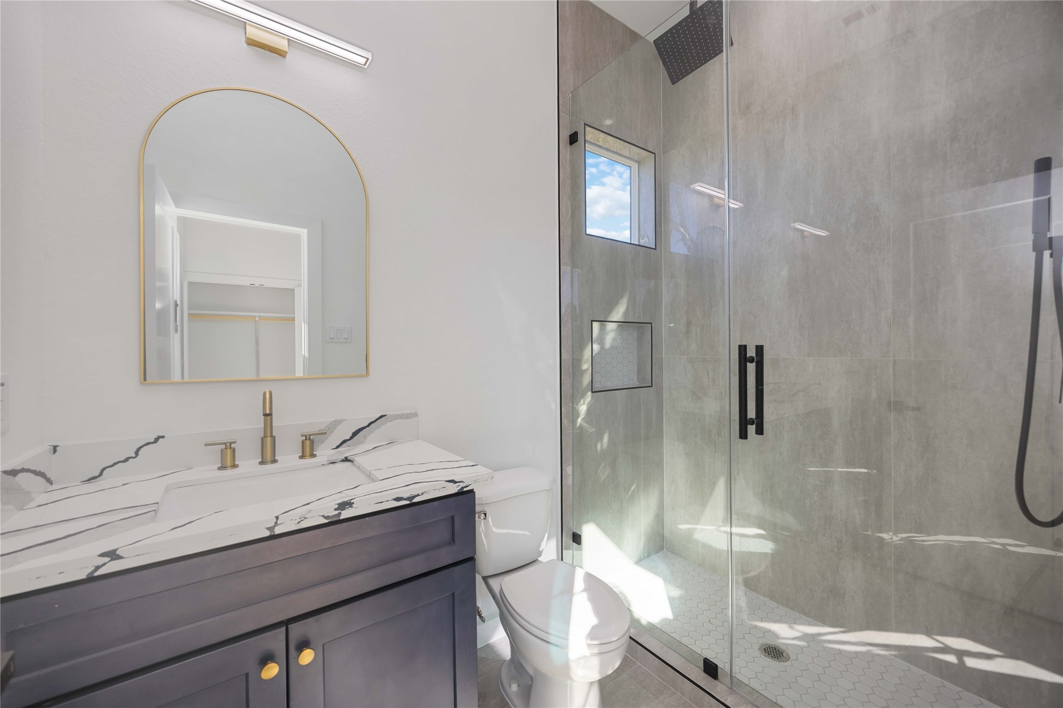 4533 Bricker Street Houston, TX 77051 - Photo 19 of 21 a bathroom with a granite countertop sink a toilet and shower