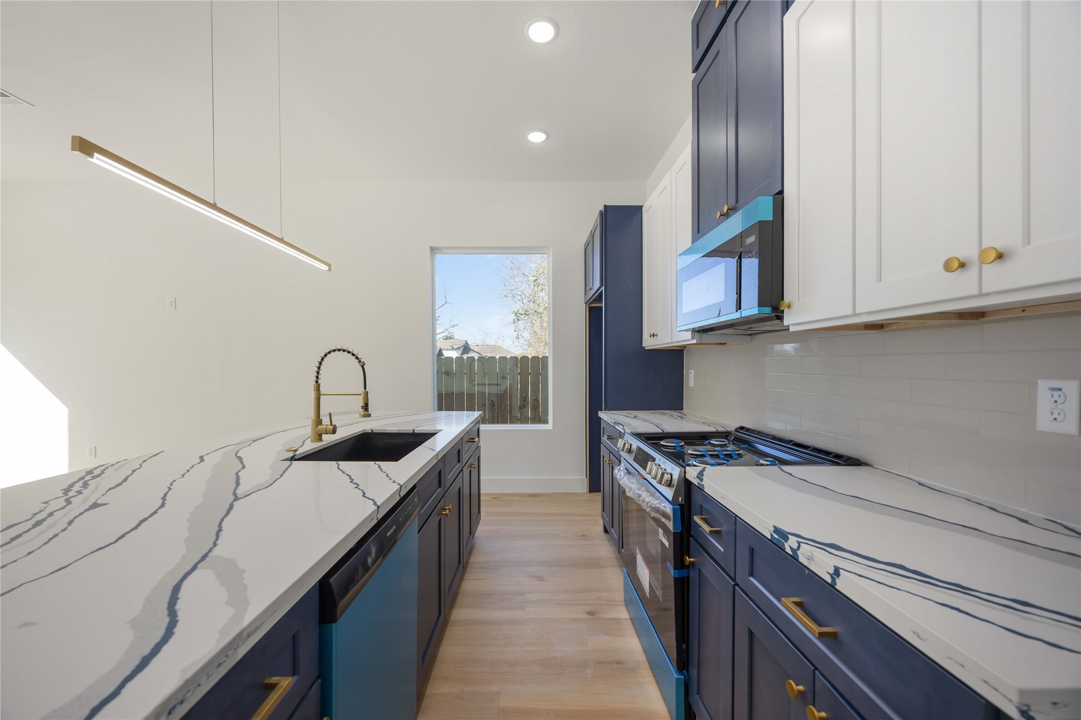 4533 Bricker Street Houston, TX 77051 - Photo 10 of 21 a kitchen with stainless steel appliances granite countertop a sink a stove and a refrigerator