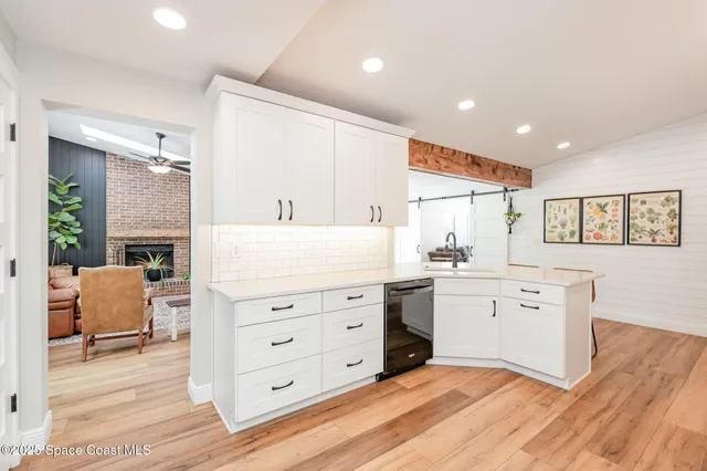 a spacious bathroom with a granite countertop sink mirror and